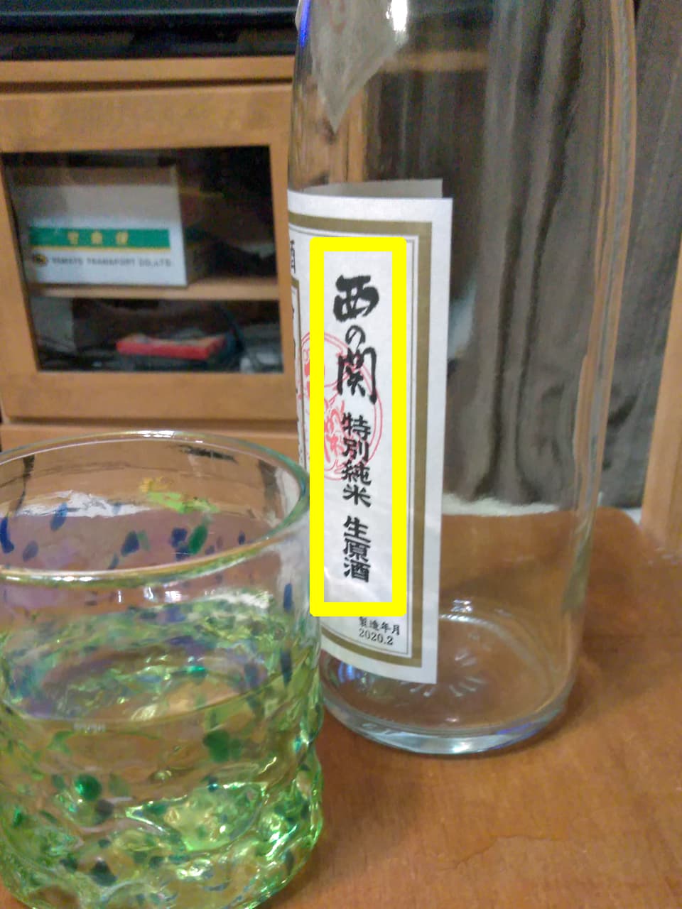 コップに入ったお酒とボトルの写真